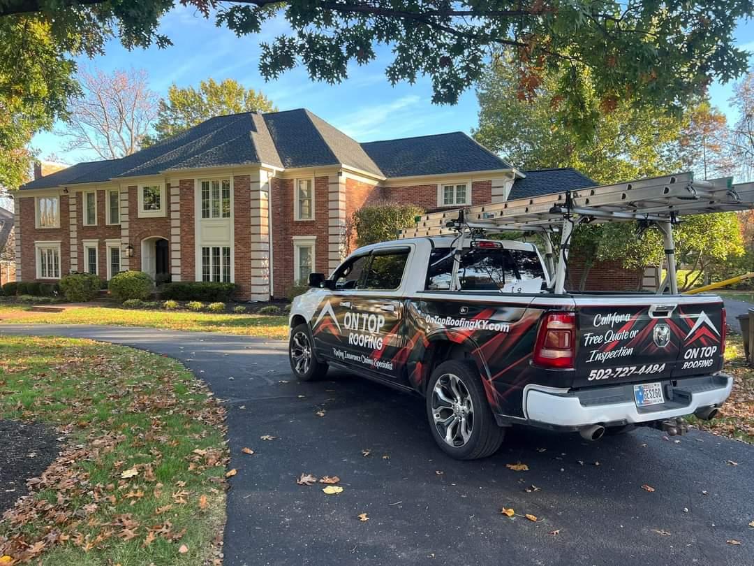 On Top Roofing Work truck in front of a large residential home in Louisville Kentucky